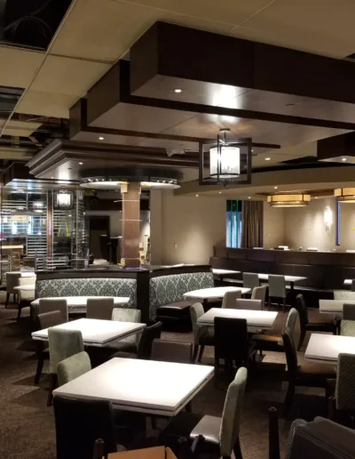The inside of a restaurant with tables and chairs.